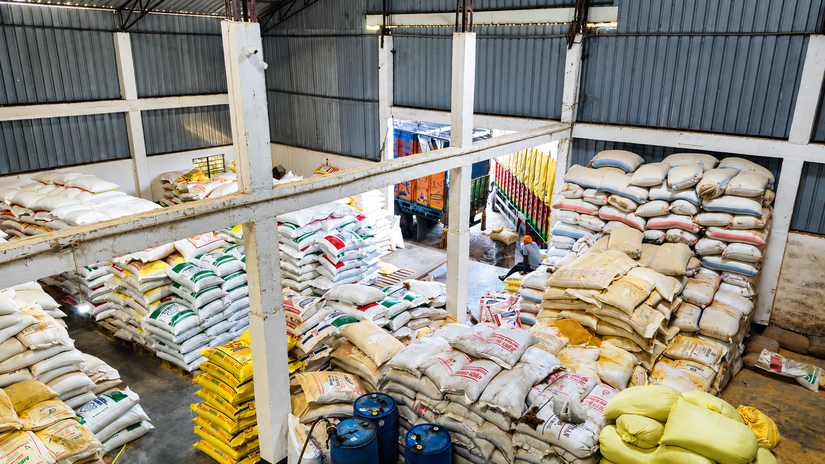 Eastern Feeds feed storage warehouse — stacked bags and loading